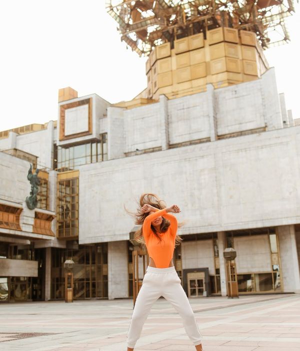 Woman feeling energetic and full of life in a bright open space.